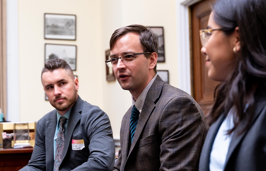 Staff and volunteers in meetings at the Capitol on World Refugee Day 2023.