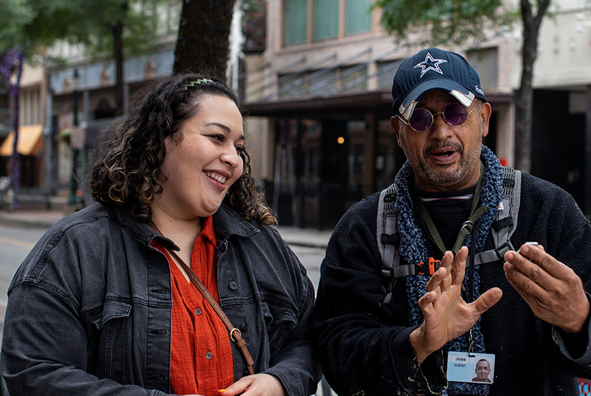 Jose shares his art with a woman.